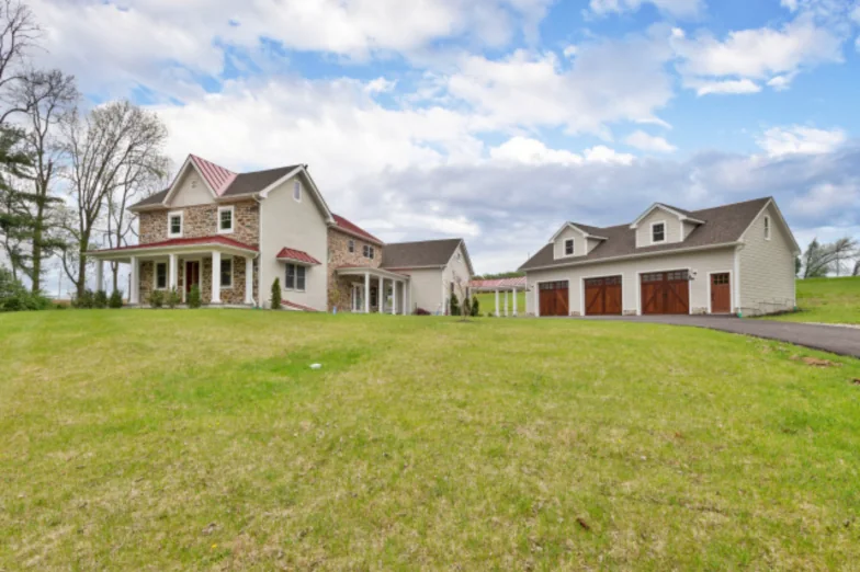 Stone farmhouse with new additions and a detached three-bay carriage garage