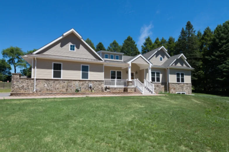 Custom home with stone base, covered front porch and multiple gables